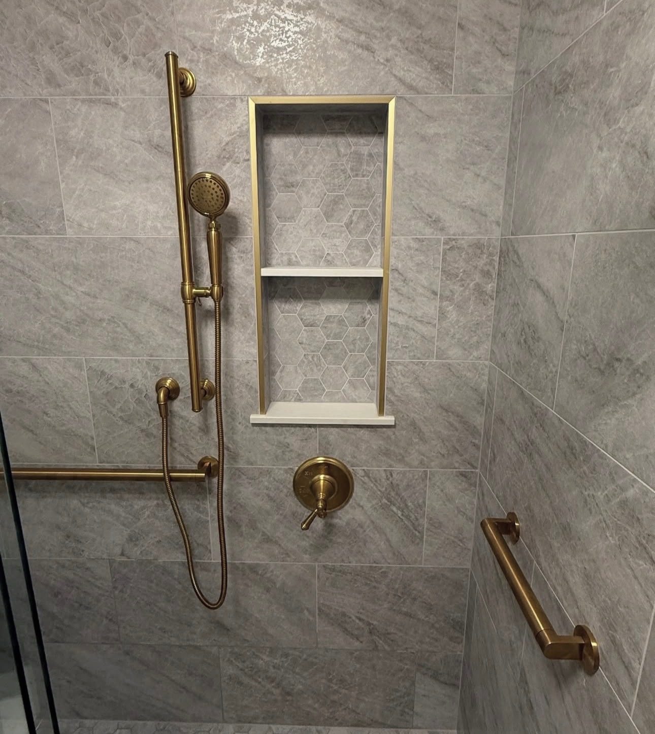Bathroom remodel with brushed gold fixtures and large-format tile